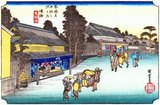 Narumi: A woman carried in a kago and two others walking in front, followed by a man on horseback and two attendants, passing two large open shops in the main street, where dyed cloths are sold. On the fascia over the front of the nearer shop is the monogram Hiro in the centre, and that of the publisher, Take-no-Uchi, each side of it.<br/><br/>

This station and the nearby town of Arimatsu are both famous for the production of tie-dyed fabrics which were suitable for making yukata, the kimono worn in summer and after a bath.<br/><br/>

Utagawa Hiroshige (歌川 広重, 1797 – October 12, 1858) was a Japanese ukiyo-e artist, and one of the last great artists in that tradition. He was also referred to as Andō Hiroshige (安藤 広重) (an irregular combination of family name and art name) and by the art name of Ichiyūsai Hiroshige (一幽斎廣重).<br/><br/>

The Tōkaidō (東海道 East Sea Road) was the most important of the Five Routes of the Edo period, connecting Edo (modern-day Tokyo) to Kyoto in Japan. Unlike the inland and less heavily travelled Nakasendō, the Tōkaidō travelled along the sea coast of eastern Honshū, hence the route's name.